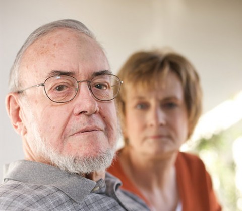 An elderly father and adult daughter during mediation
