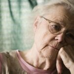 Elderly woman with dementia staring into space