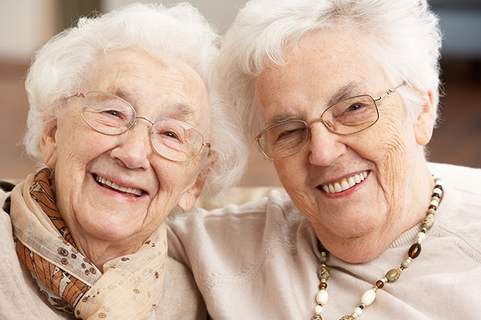 Two healthy elderly women smiling