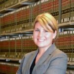 A photo of Sarah Hooper in front of law books