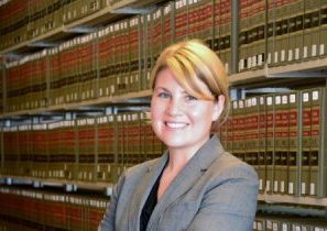 A photo of Sarah Hooper in front of law books