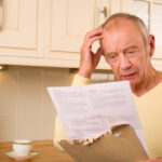 Senior man looking at a high medical bill