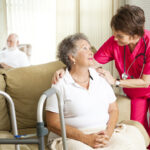 Elderly obese person with caregiver