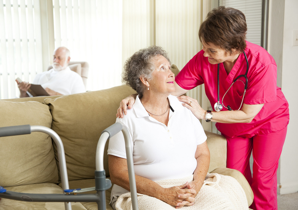 Elderly obese person with caregiver