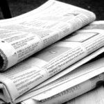A stack of newspapers sitting on a table