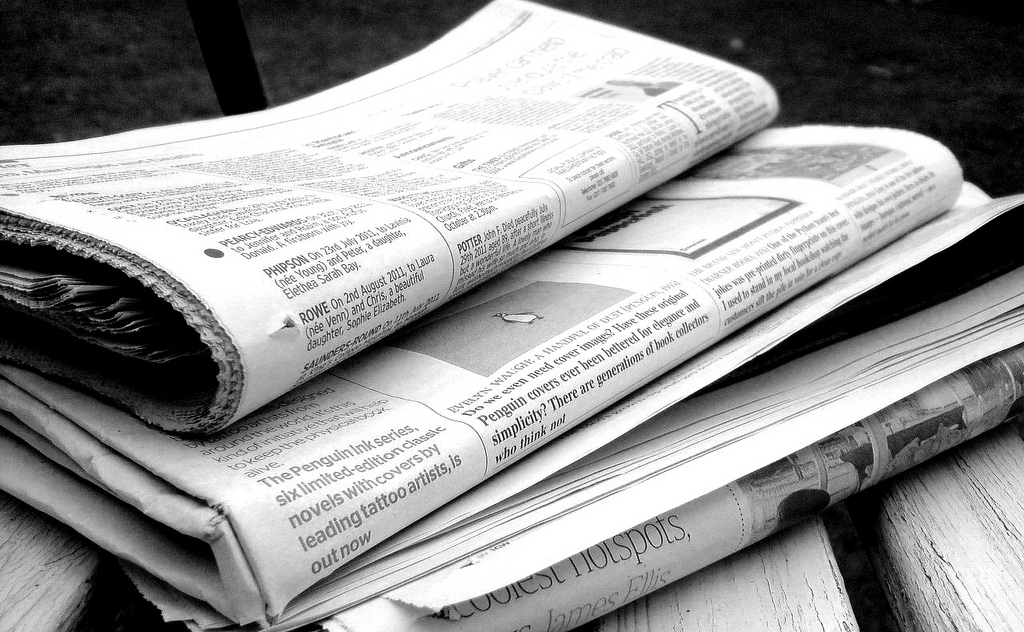 A stack of newspapers sitting on a table