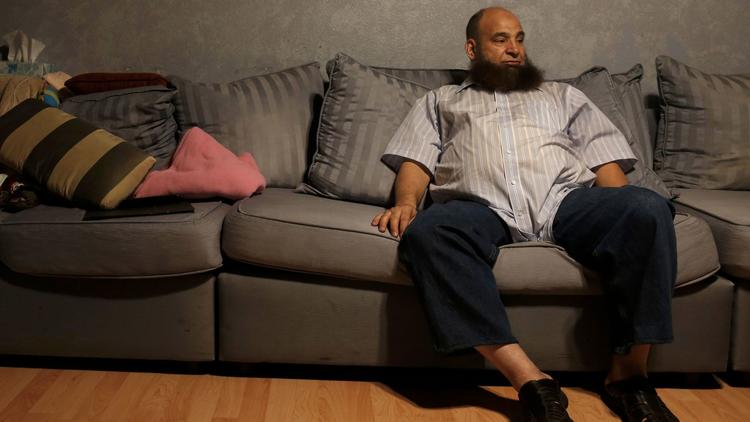 Mohamed Bzeek sitting on living room couch