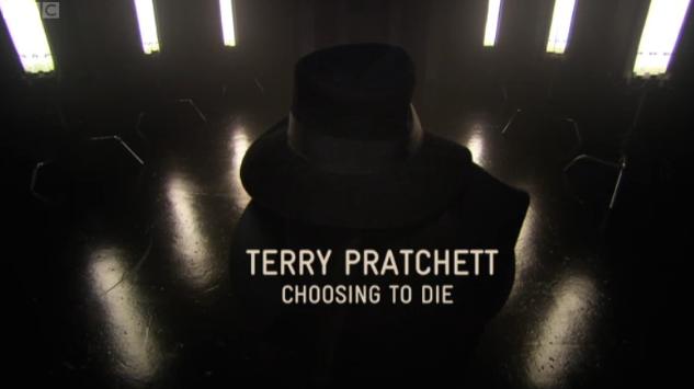 A screenshot from Terry Pratchett: Choosing to Die showing Pratchett in the shadows, wearing a black fedora hat