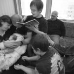 a family says goodbye to their infant who has died
