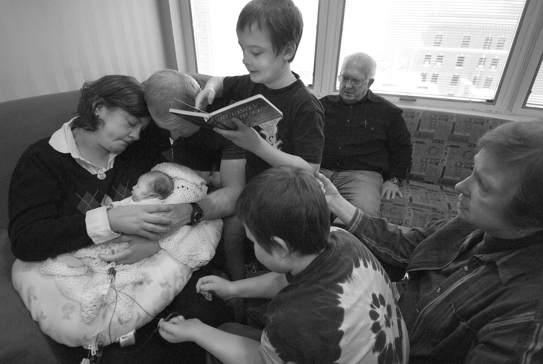 a family says goodbye to their infant who has died