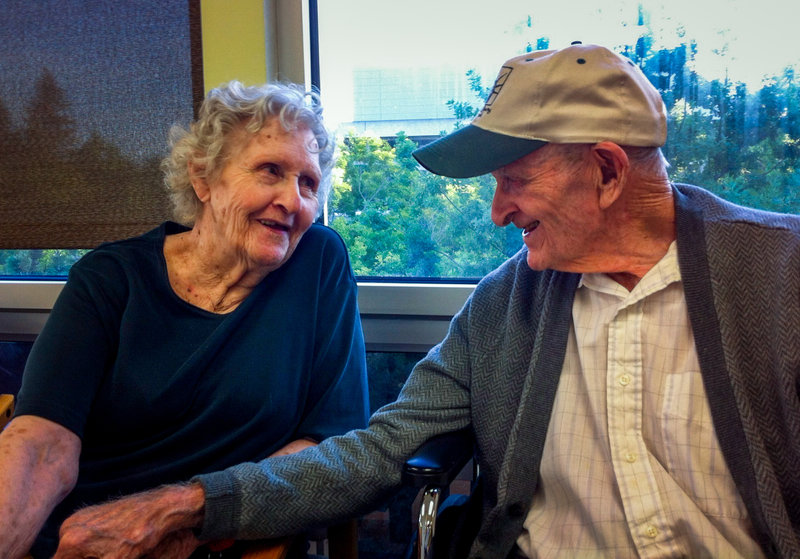 Gloria Single sits next to her husband, Bill Single in a nursing home; AARP Foundation is suing the home for illegal nursing home evictions