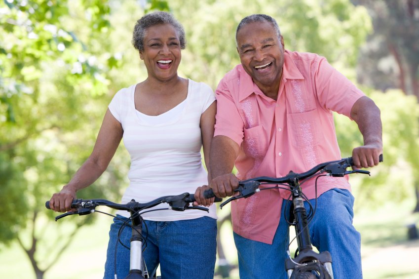 Elderly couple riding bicycles symbolizing exercise.