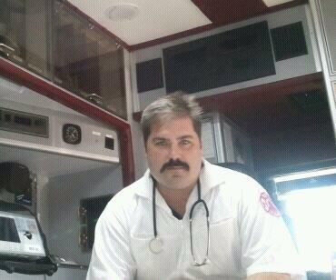 A photo of Dennis Kowalski sitting in an emergency vehicle