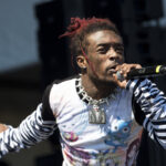 Lil Uzi Vert performing a song on stage symbolizing the rise of death as a topic in pop music.