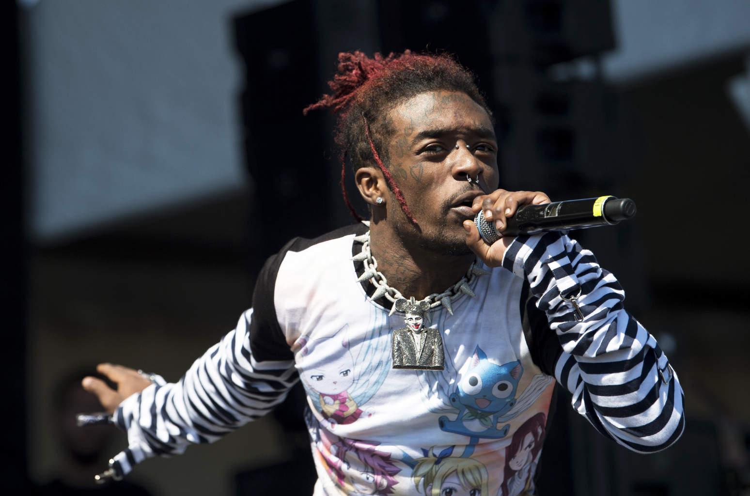 Lil Uzi Vert performing a song on stage symbolizing the rise of death as a topic in pop music.