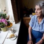 Elderly woman staring out the window is predicposed to self-neglect