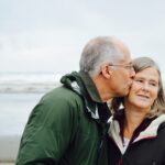 An older couple on the beach thinking about retirement