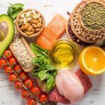 Fruit, grains, salmon and healthy food displayed in the shape of a heart.