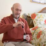 Image of a senior citizen using a medical cannabis tincture
