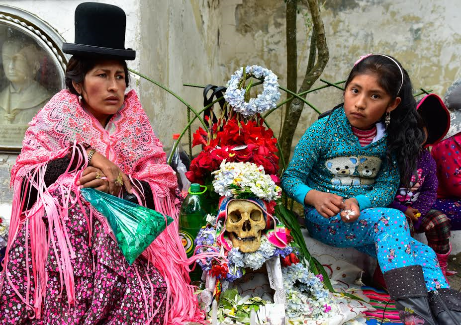 Armayan woman and child sitting next to a natita skull.