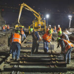 Construction workers operating during a night shift.