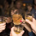 Young people raising glasses filled with alcohol leading to deaths from liver disease