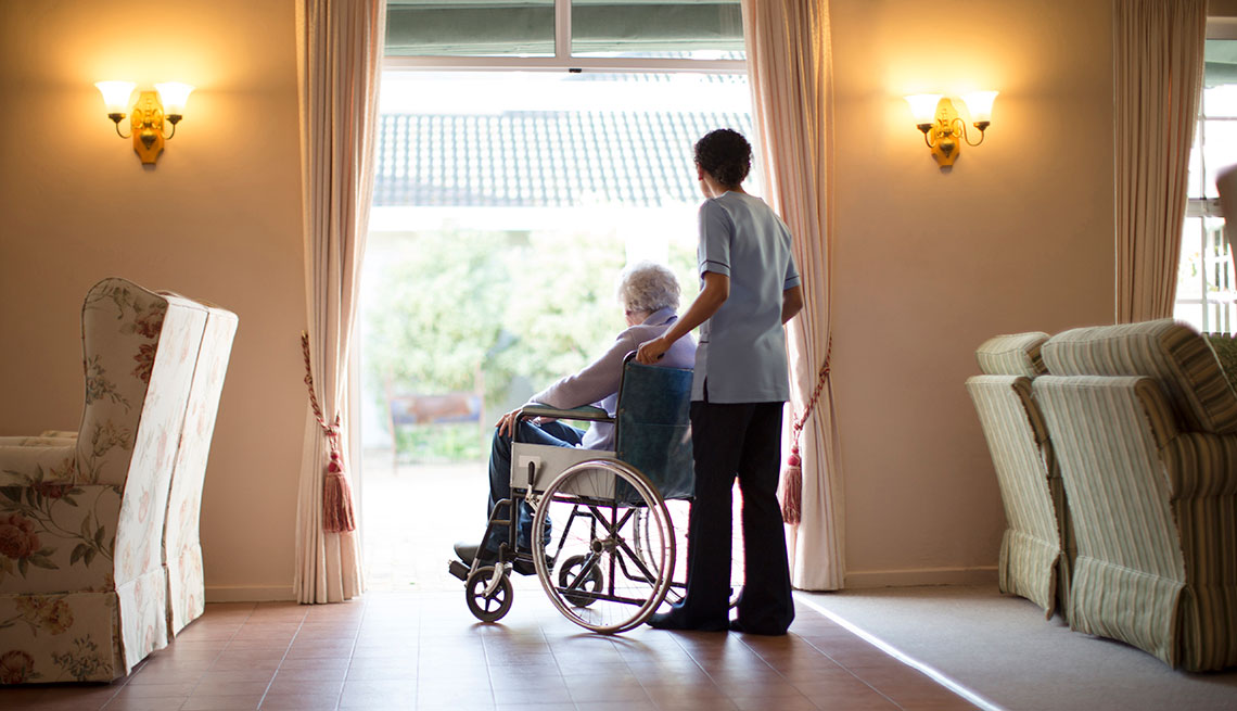 A man sits in a wheelchari in an assisted living facility