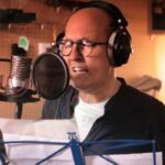 Photo of Mike Jacobs recording his song "Stay" in a studio.