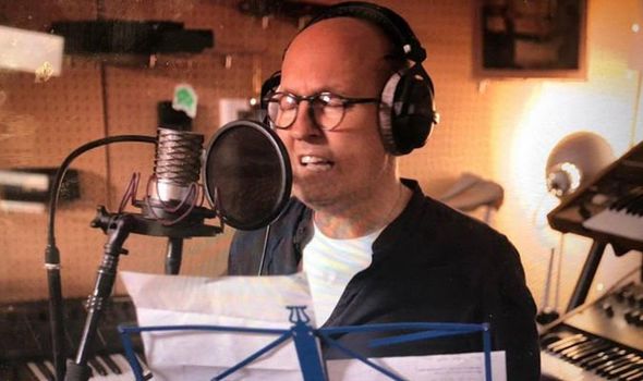 Photo of Mike Jacobs recording his song "Stay" in a studio.