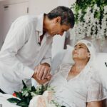 Colin and Tracey MacDonald holding hands during their wedding.