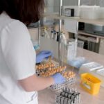 Medical professional performing a blood test in a lab.