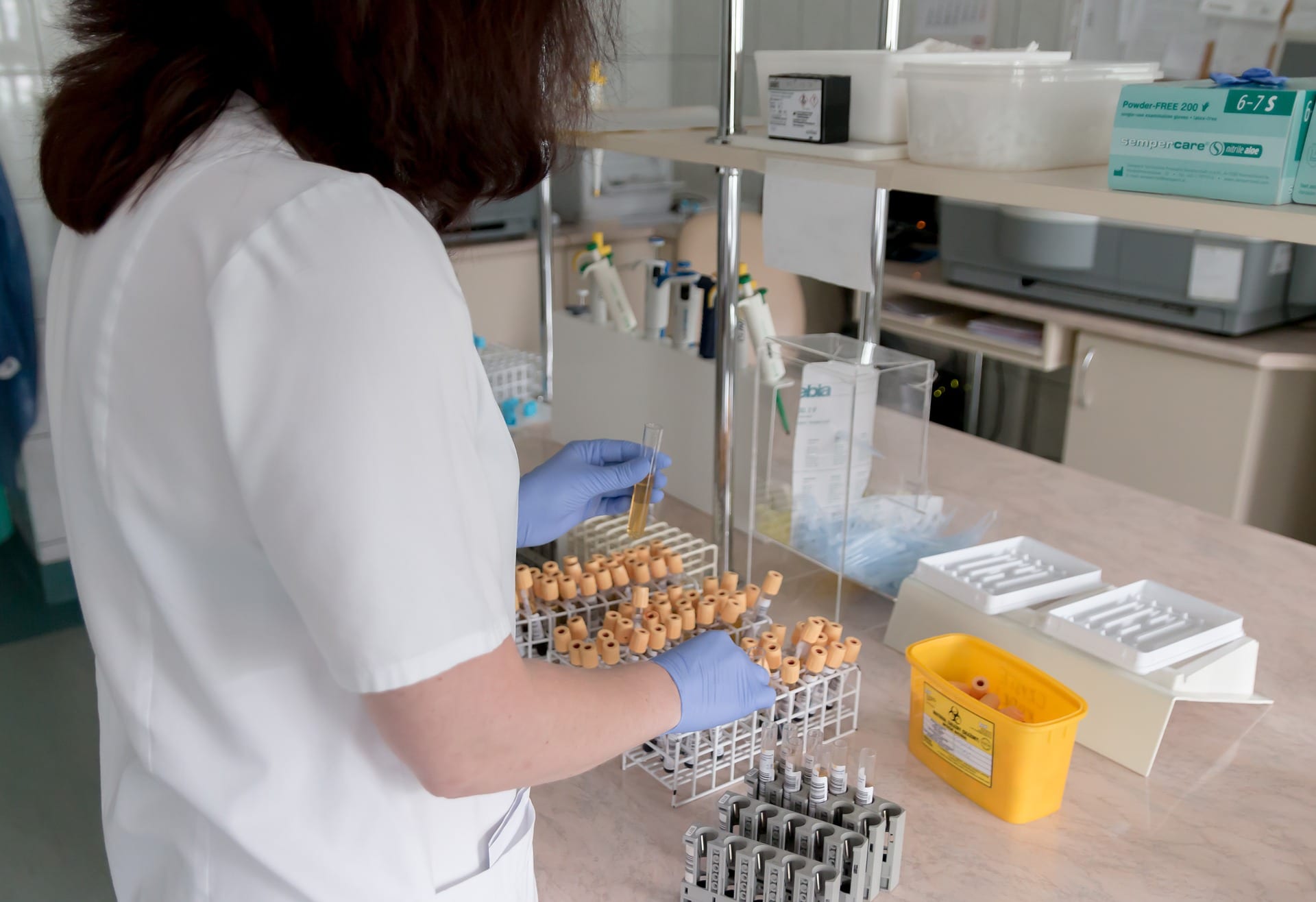Medical professional performing a blood test in a lab.