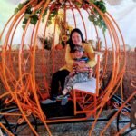 Emily Kil and her three-year-old son sitting in a metal carriage.