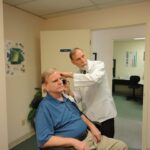 Image of man in doctor's office for age-related hearing impairment