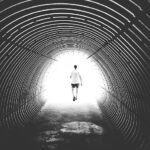 Man running through a tunnel, representing a near death experience.