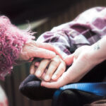 Three hands touching - crowdfunding funerals