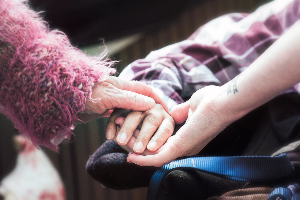 Three hands touching - crowdfunding funerals