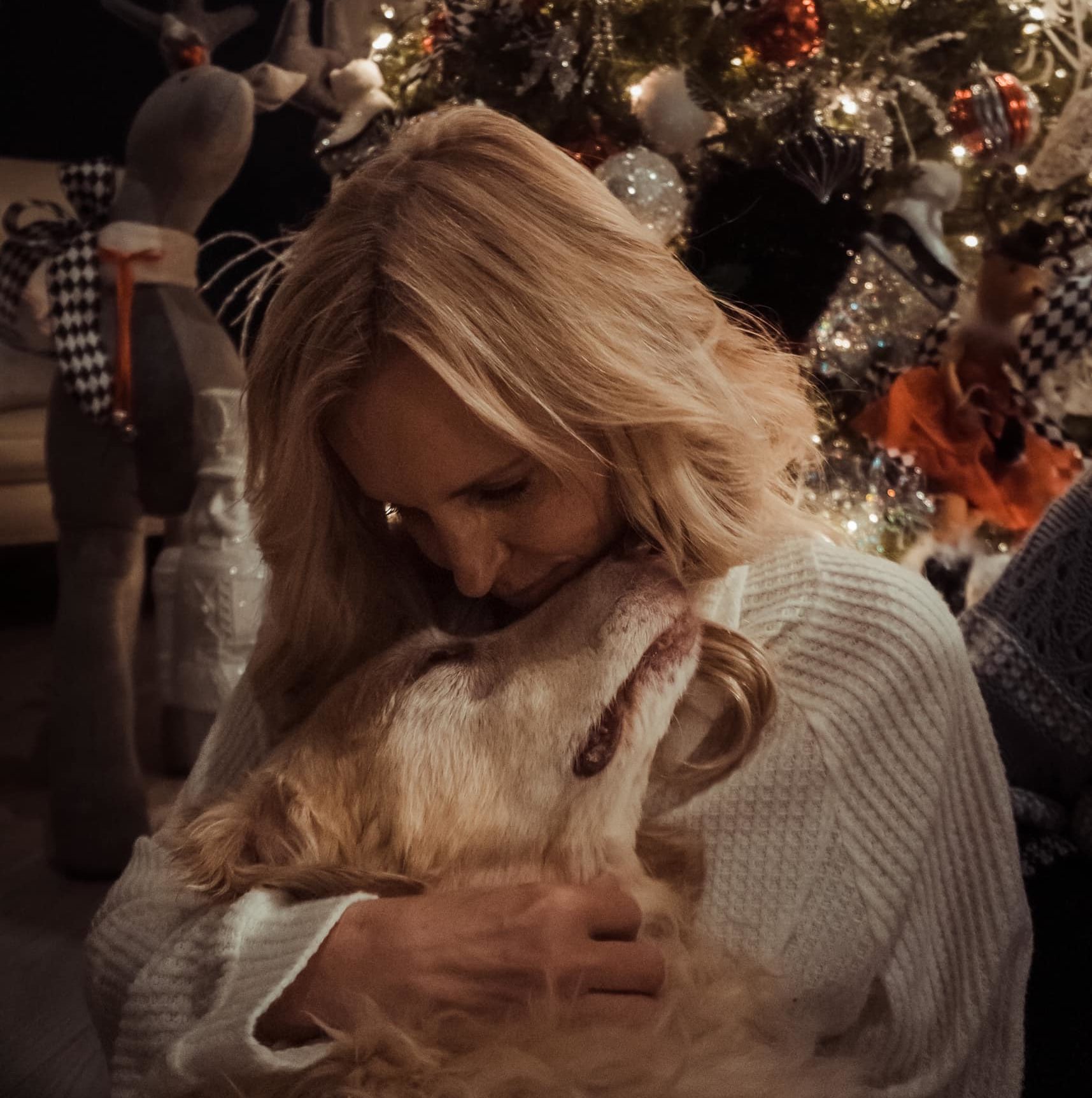 woman hugs her dog for end of life photograph