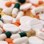 different types of pills scattered on a surface