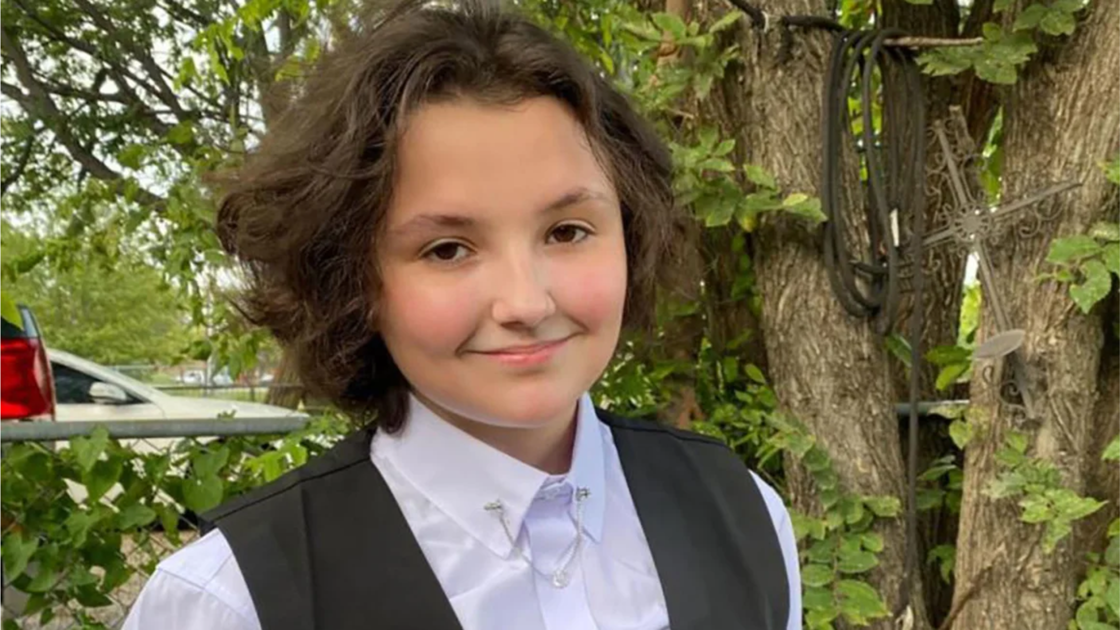 A photo of Nex Benedict, a young nonbinary person with chin-length hair and a sweet smile.