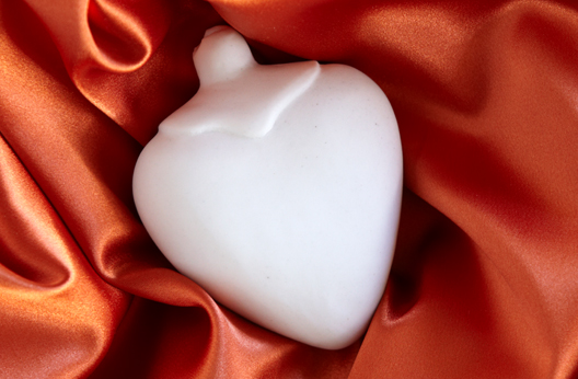 Woman standing in the shower with her face contorted in grief over the death of a loved one