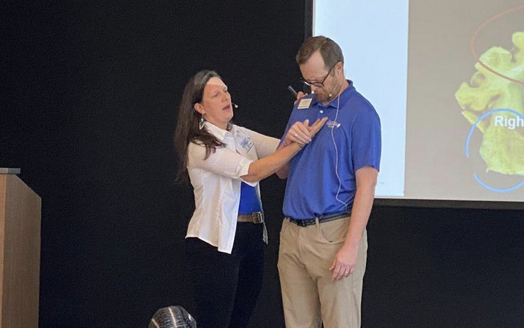 A woman and man onstage at a dementia care training