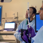Doctors look at a screen on which medical imaging is being projected