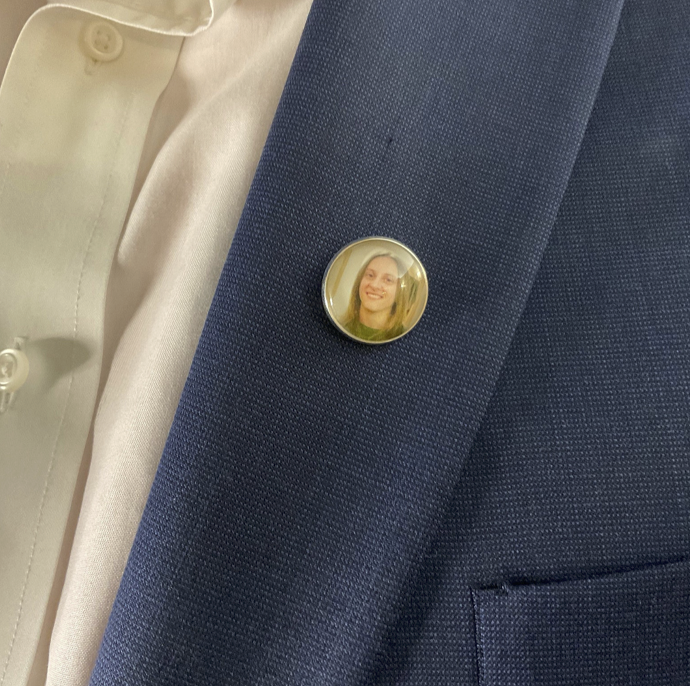 Memorial pin on jacket lapel.