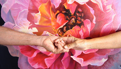 Old man and woman holding hands to signify their end of life