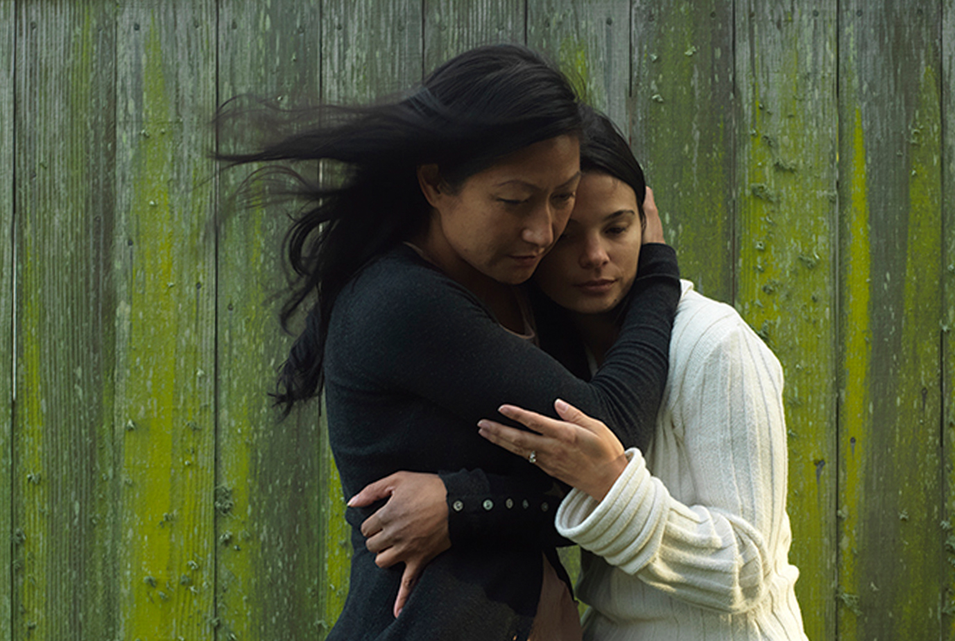 two women hugging and mourning a death