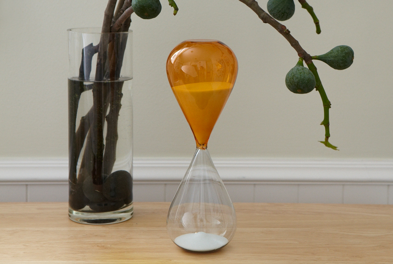 an orange hour glass sits on a table signifying terminal illness and the passage of time