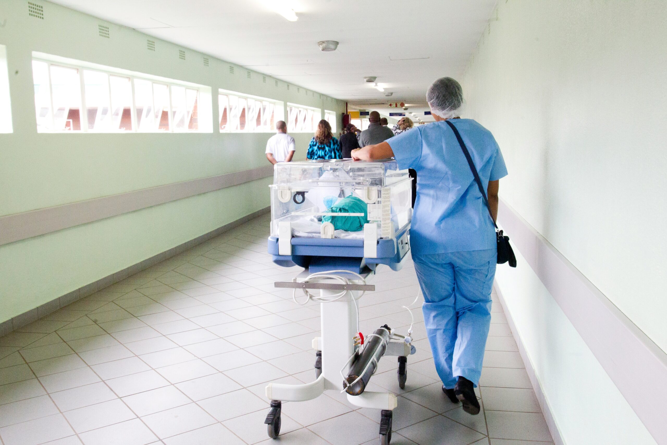 a doctor is pushing an organ transplant donation through a hospital hallway