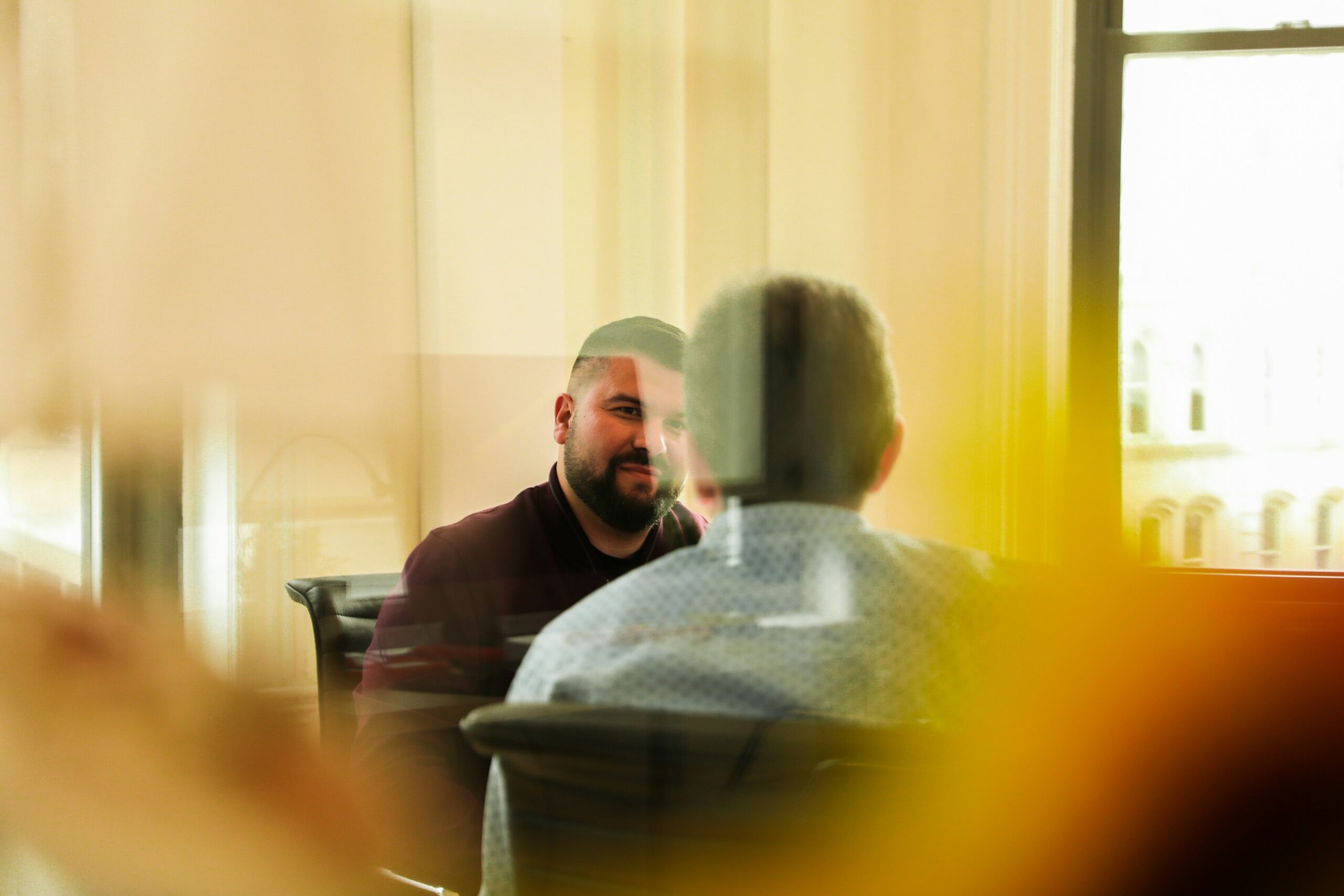 two men sit in chairs discussing healthcare proxies