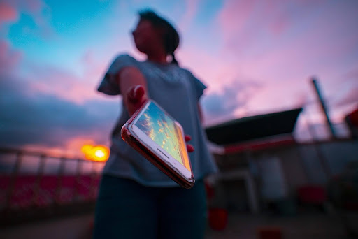 person holding out smart phone